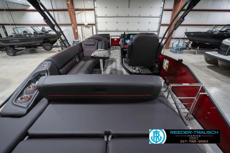 Slide: The Image of 2026 Bennington 25 RSB boat interior with luxurious seating and modern design in a showroom. - 19