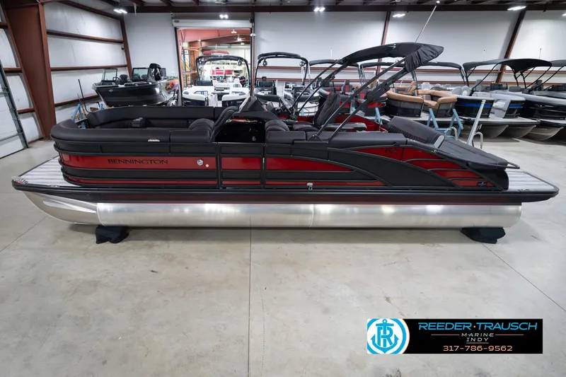 Slide: The Image of 2026 Bennington 25 RSB pontoon boat in showroom, featuring sleek design and modern amenities. - 2