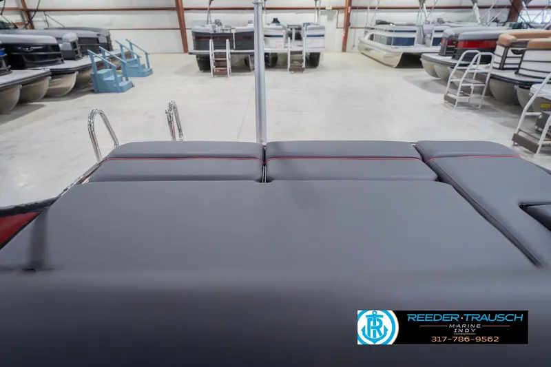 Slide: The Image of 2026 Bennington 25 RSB boat interior in showroom, featuring sleek seating and modern design. - 33