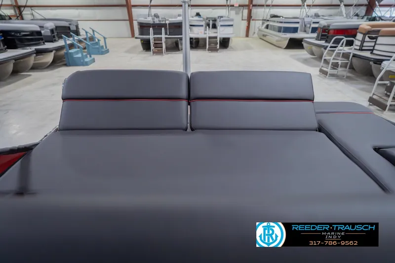 Slide: The Image of 2026 Bennington 25 RSB boat interior with gray seating in a showroom. - 34