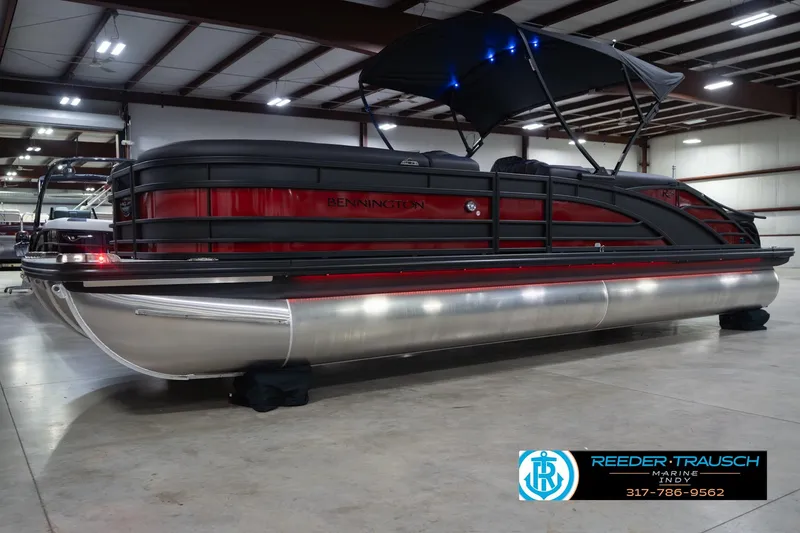 Slide: The Image of 2026 Bennington 25 RSB pontoon boat in showroom with canopy and sleek design. - 4
