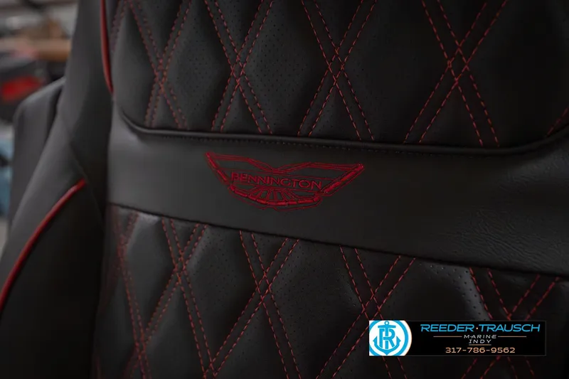 Slide: The Image of Luxurious Bennington 25 RSB 2026 boat seat with red stitching and logo detail. - 44