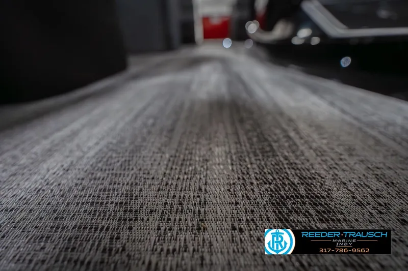 Slide: The Image of 2026 Bennington 25 RSB boat flooring, textured surface, Reeder-Trausch Marine logo visible. - 51