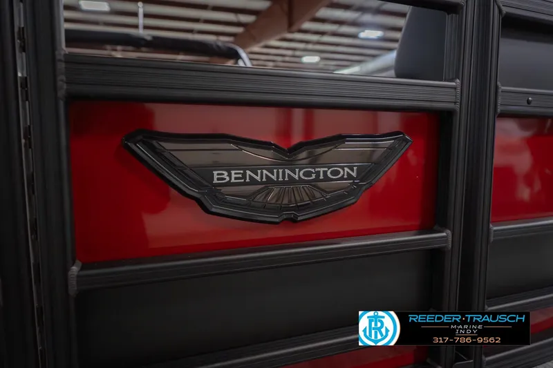 Slide: The Image of 2026 Bennington 25 RSB boat logo on red and black paneling. - 52