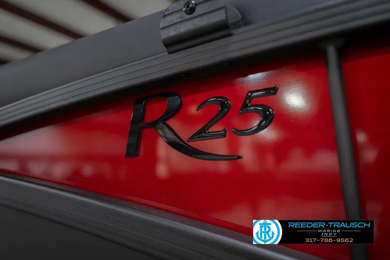 Slide: The Image of 2026 Bennington 25 RSB boat, red exterior with R25 logo, Reeder Trausch Marine branding. - 54