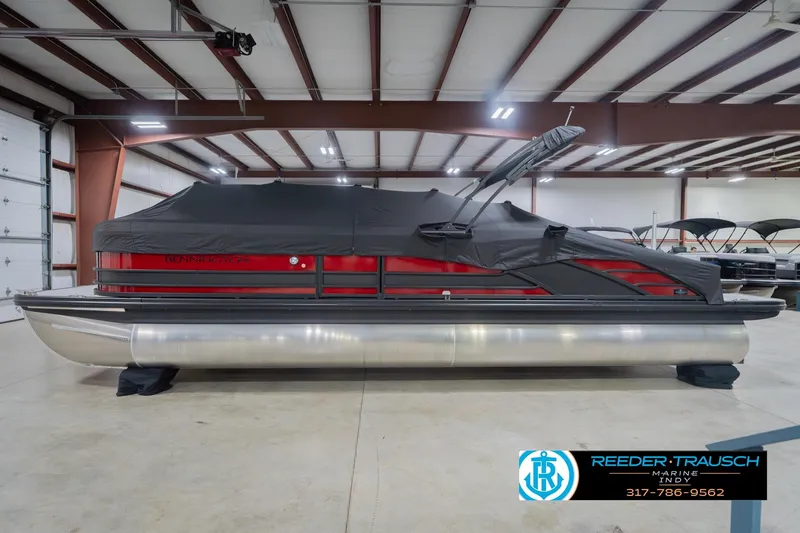 Slide: The Image of 2026 Bennington 25 RSB pontoon boat in a showroom, covered and ready for display. - 57