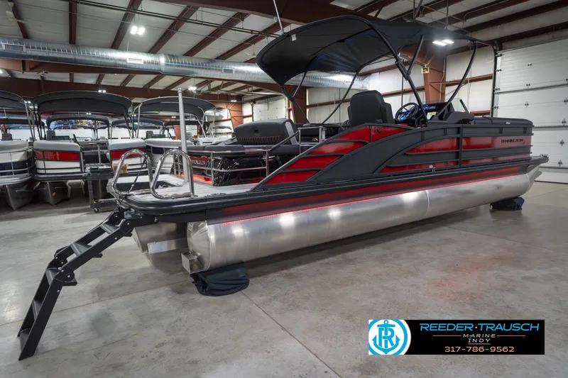 Slide: The Image of 2026 Bennington 25 RSB pontoon boat in showroom, featuring sleek design and modern amenities. - 8