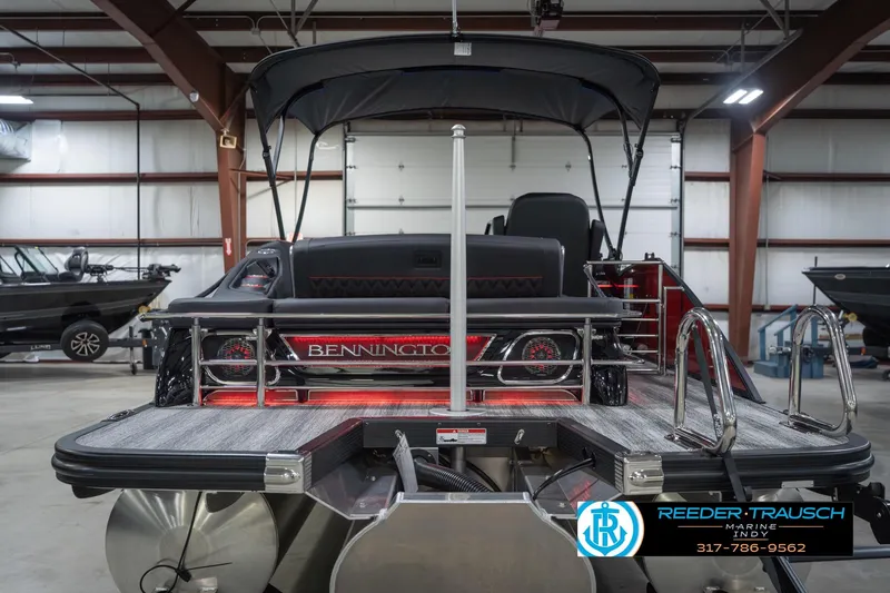 Slide: The Image of 2026 Bennington 25 RSB pontoon boat in showroom, featuring sleek design and modern amenities. - 9