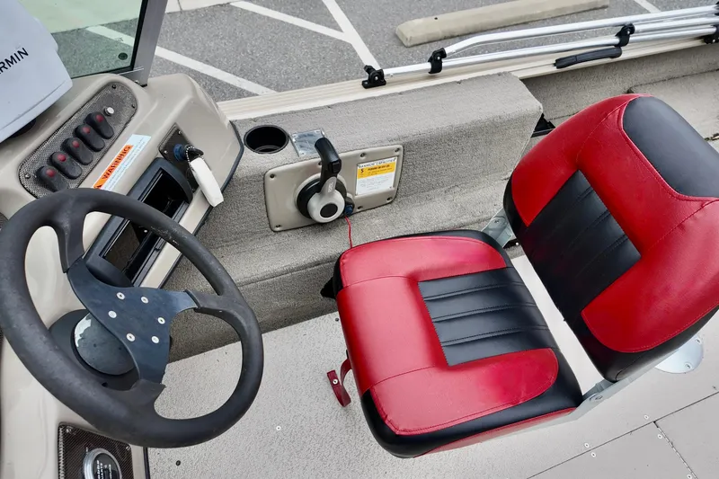 Slide: The Image of 2013 G3 Angler V172 F boat interior with steering wheel and red-black seat. - 8