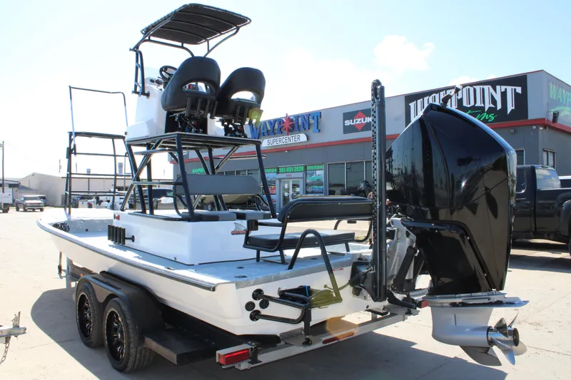 Slide: The Image of 2024 Shoalwater 23 Catamaran boat with elevated seating and sturdy frame, parked outdoors. - 10