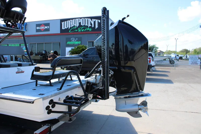 Slide: The Image of 2024 Shoalwater 23 Catamaran tower against blue sky, showcasing elevated helm station. - 11