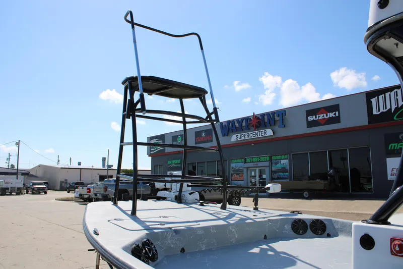 Slide: The Image of 2024 Shoalwater 23 Catamaran helm with seating and canopy against blue sky. - 13