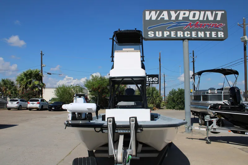 Slide: The Image of 2024 Shoalwater 23 Catamaran on trailer, parked outdoors under blue sky. - 19
