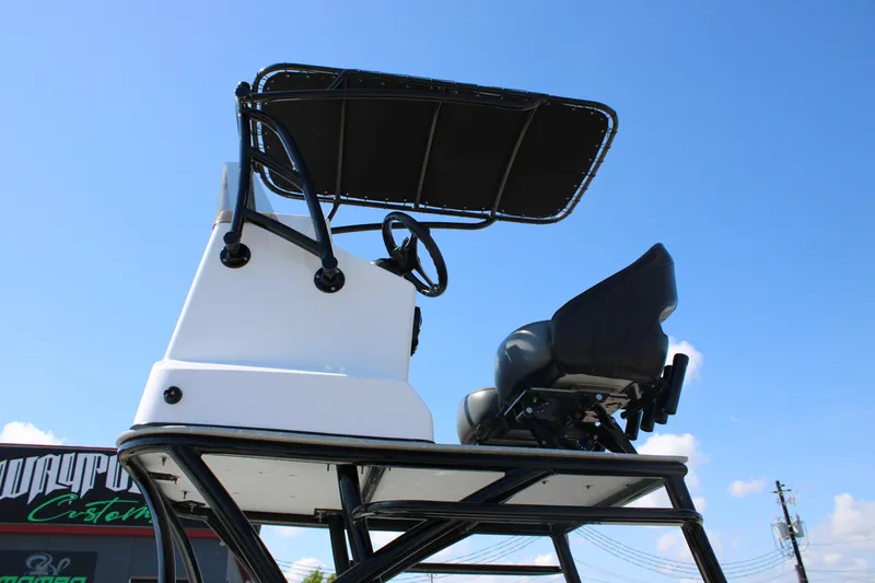 Slide: The Image of 2024 Shoalwater 23 Catamaran displayed at a marine supercenter under clear blue skies. - 2