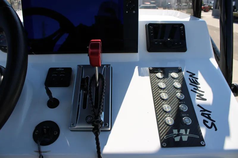 Slide: The Image of Steering wheel of 2024 Shoalwater 23 Catamaran with control panel and navigation display. - 29