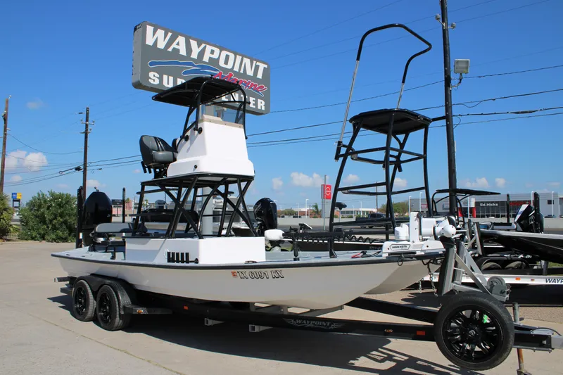 Slide: The Image of 2024 Shoalwater 23 Catamaran boat on trailer, featuring elevated seating and powerful outboard motor. - 3