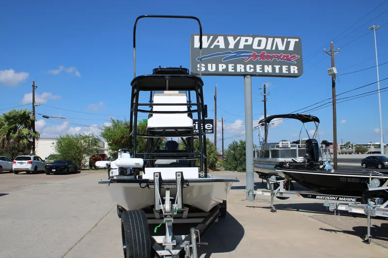 Slide: The Image of 2024 Shoalwater 23 Catamaran boat with dual seats and powerful outboard motor. - 4