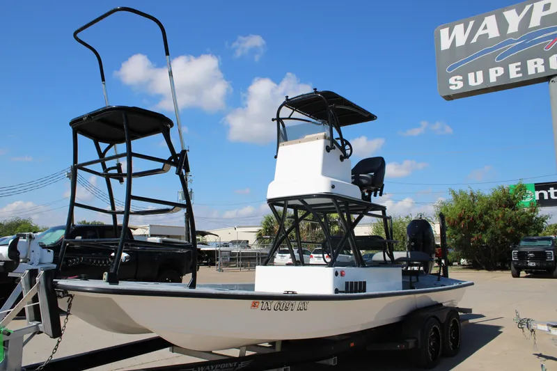 Slide: The Image of 2024 Shoalwater 23 Catamaran with outboard motor, displayed at a dealership. - 5