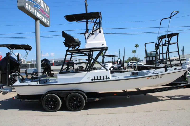 Slide: The Image of 2024 Shoalwater 23 Catamaran boat on trailer, displayed outside dealership. - 6