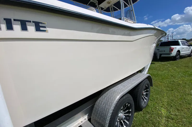 Slide: The Image of 2005 Grady-White Advance 257 boat on trailer, parked on grass under blue sky. - 10