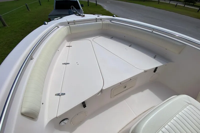 Slide: The Image of 2005 Grady-White Advance 257 boat interior with cushioned seating and storage compartments. - 100