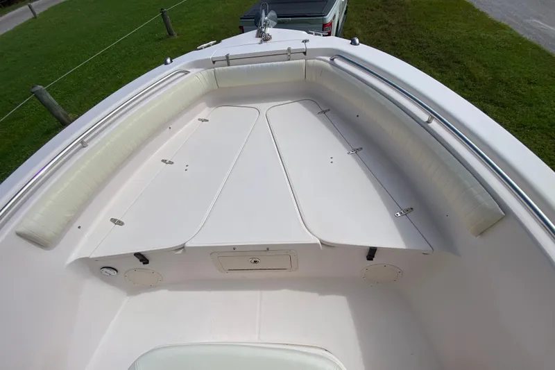 Slide: The Image of 2005 Grady-White Advance 257 boat bow with cushioned seating and storage compartments. - 101