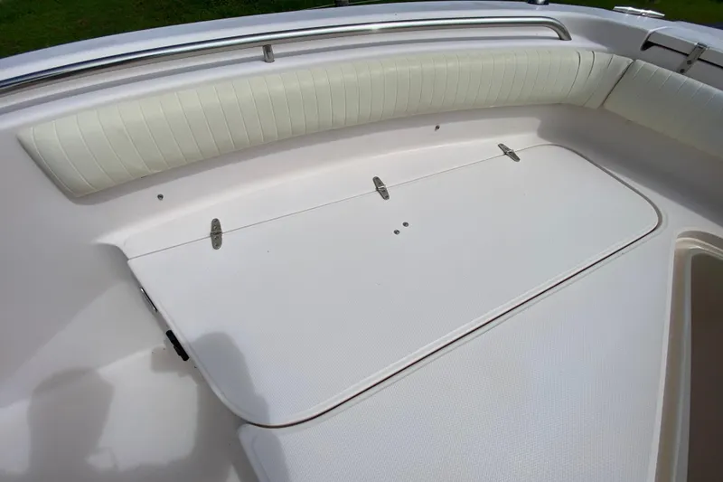 Slide: The Image of 2005 Grady-White Advance 257 boat interior with cushioned seating and storage compartment. - 104