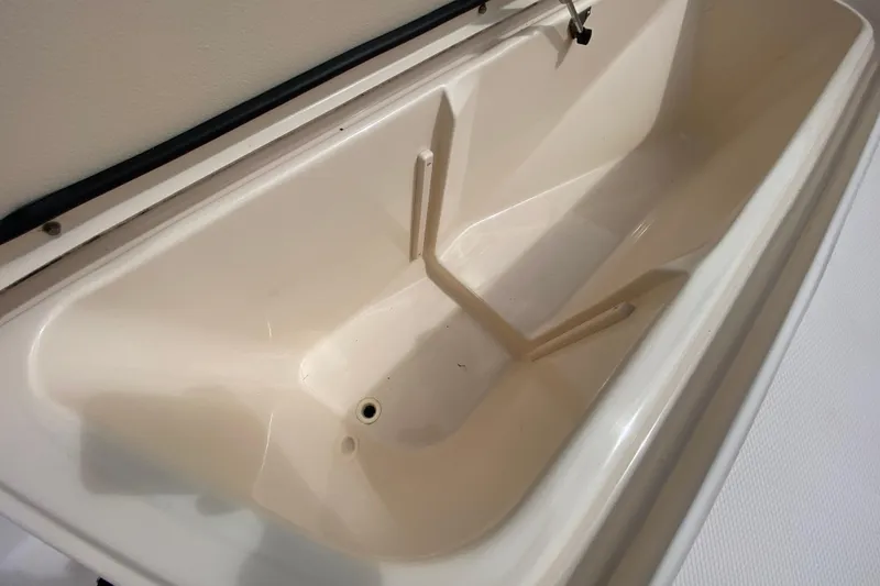 Slide: The Image of 2005 Grady-White Advance 257 boat storage compartment, open and empty. - 106