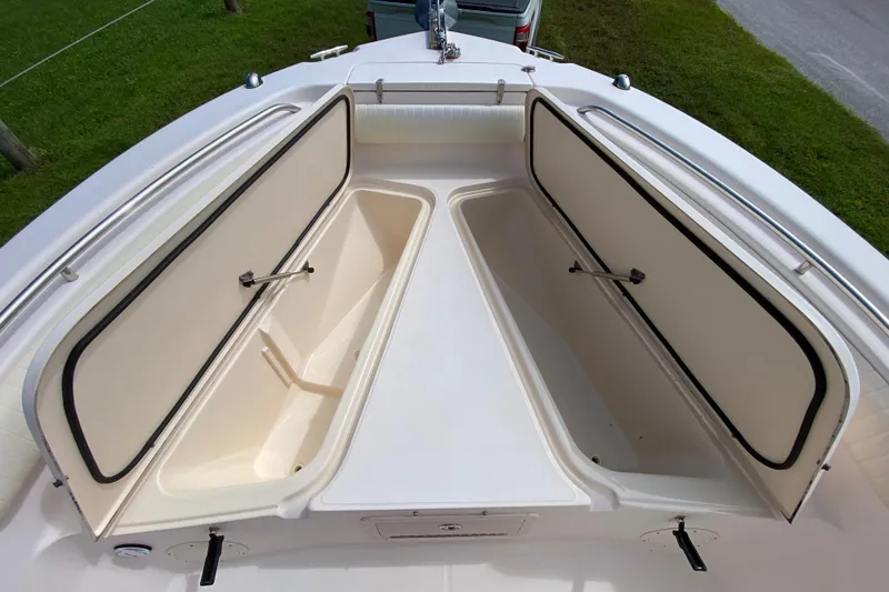 Slide: The Image of 2005 Grady-White Advance 257 boat with open storage compartments on deck. - 107