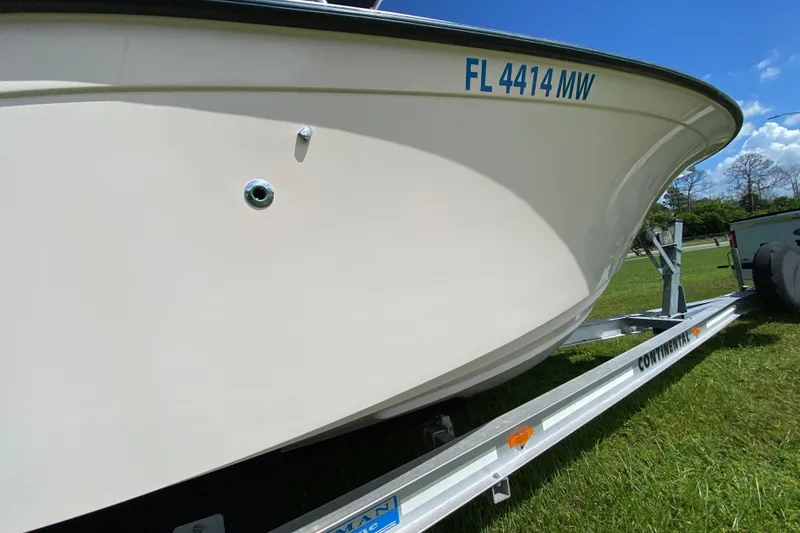 Slide: The Image of 2005 Grady-White Advance 257 boat on trailer, grassy field background. - 12