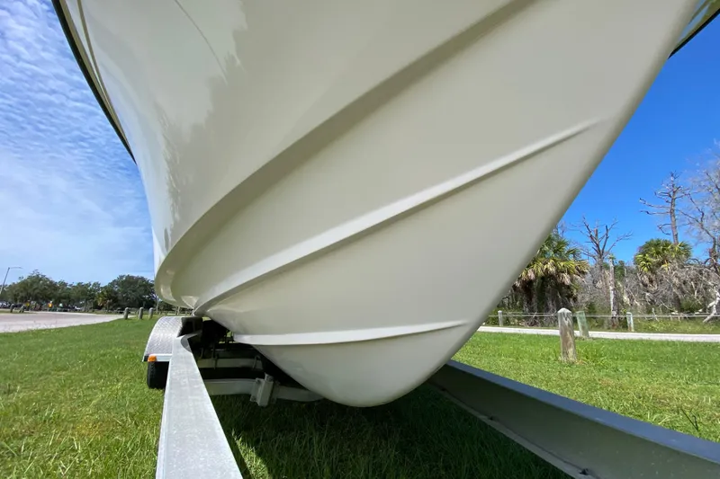 Slide: The Image of 2005 Grady-White Advance 257 boat on trailer, grassy area, clear sky. - 13