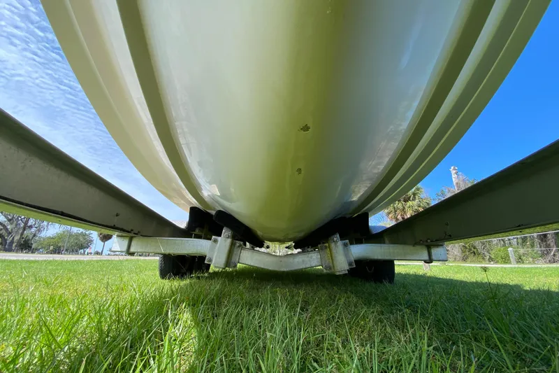 Slide: The Image of Underside view of 2005 Grady-White Advance 257 boat on trailer, grassy background. - 16