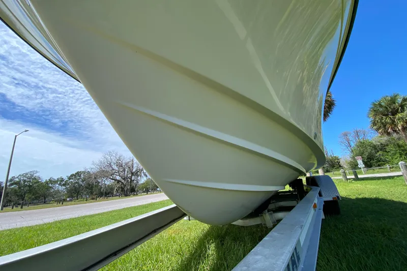 Slide: The Image of 2005 Grady-White Advance 257 boat on trailer, under clear blue sky. - 17