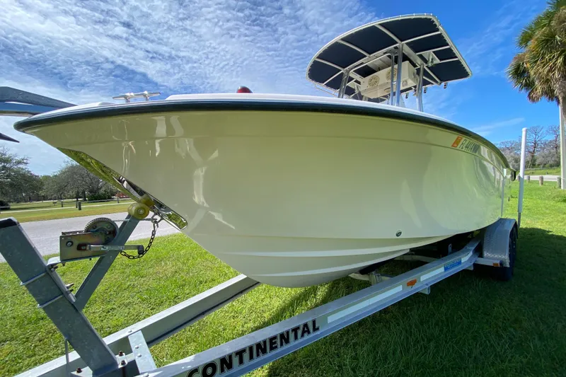 Slide: The Image of 2005 Grady-White Advance 257 boat on trailer, parked on grass under blue sky. - 19