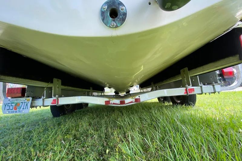 Slide: The Image of 2005 Grady-White Advance 257 boat on trailer, viewed from below, parked on grass. - 24