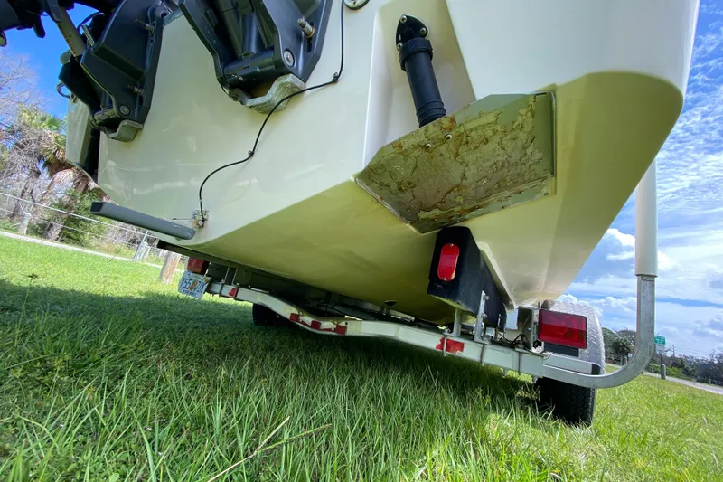 Slide: The Image of 2005 Grady-White Advance 257 boat on trailer, grassy area, under view. - 27