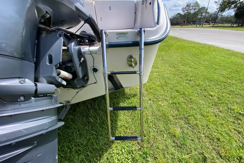 Slide: The Image of 2005 Grady-White Advance 257 boat with ladder on grassy area. - 28