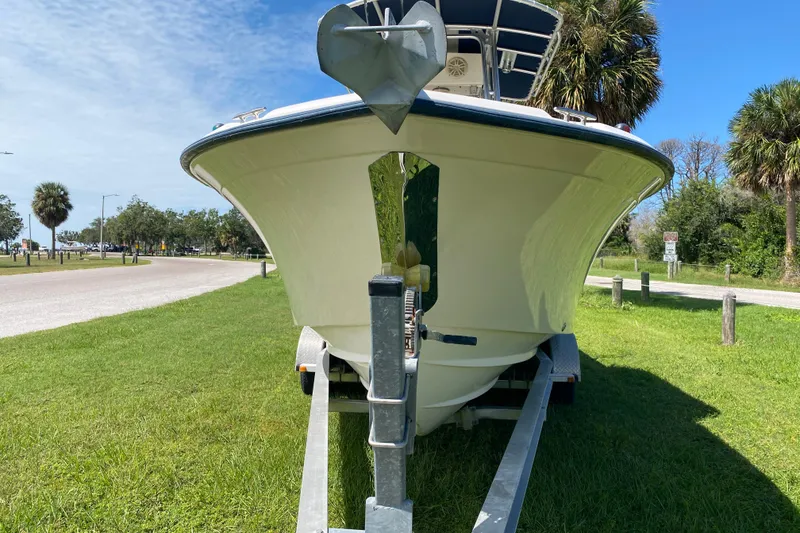 Slide: The Image of 2005 Grady-White Advance 257 boat on trailer, parked on grassy area near road. - 3