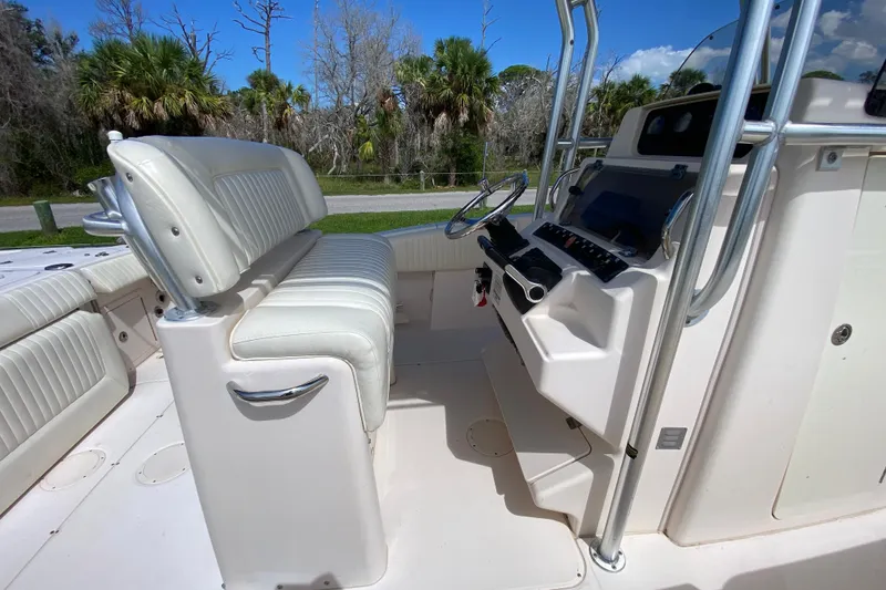 Slide: The Image of 2005 Grady-White Advance 257 boat interior with white seating and control panel. - 30