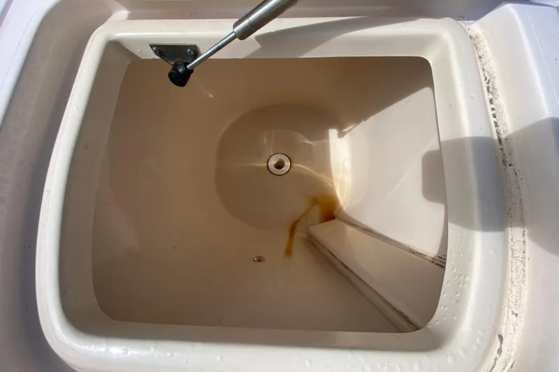 Slide: The Image of Livewell compartment in a 2005 Grady-White Advance 257 boat, showing interior details. - 39