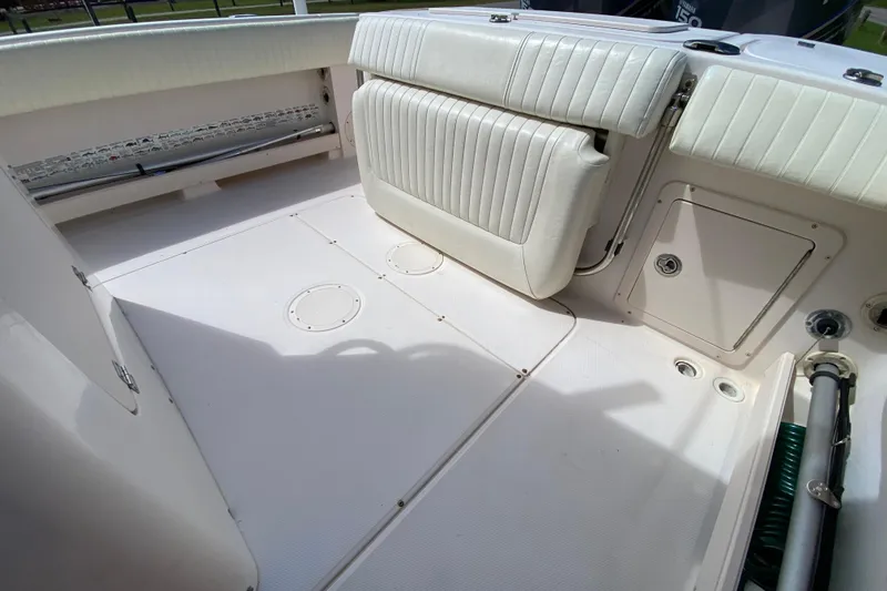 Slide: The Image of 2005 Grady-White Advance 257 boat interior with white seating and storage compartments. - 40
