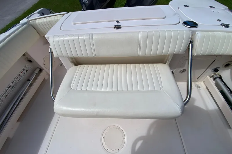 Slide: The Image of 2005 Grady-White Advance 257 boat seat with white upholstery and stainless steel supports. - 42