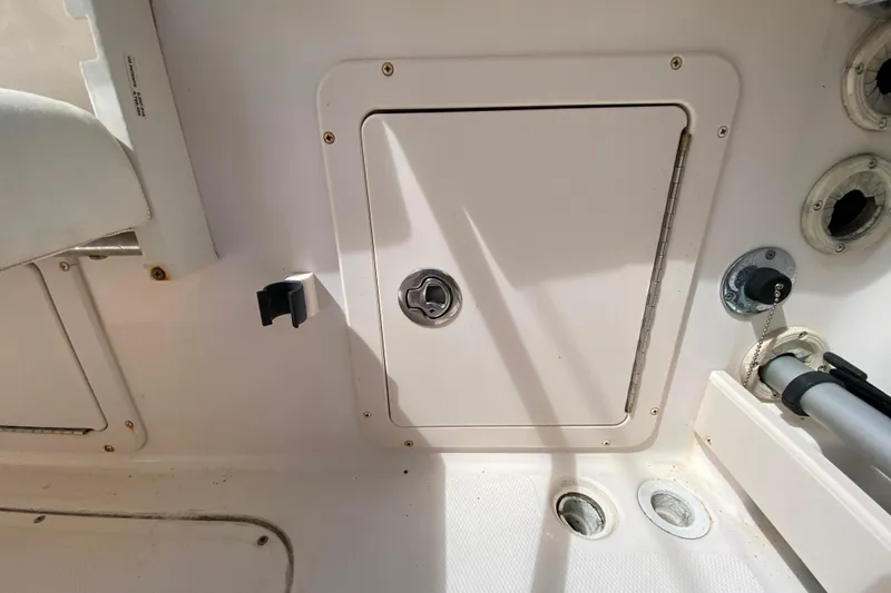 Slide: The Image of 2005 Grady-White Advance 257 boat interior storage compartment with latch and fittings. - 43