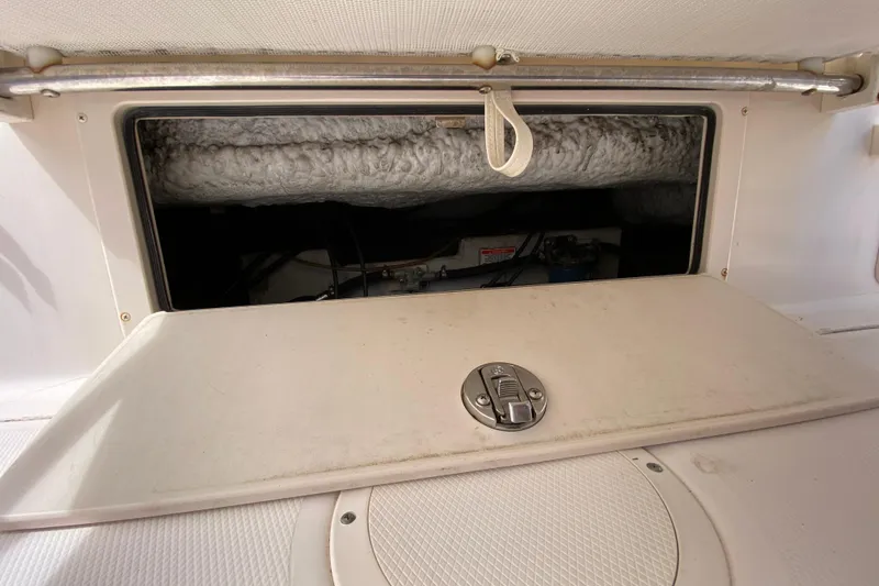 Slide: The Image of 2005 Grady-White Advance 257 boat storage compartment with open hatch and latch. - 45