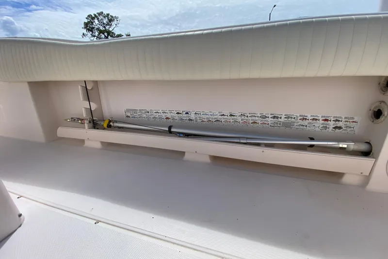 Slide: The Image of 2005 Grady-White Advance 257 boat interior with fishing rod storage and fish identification chart. - 47