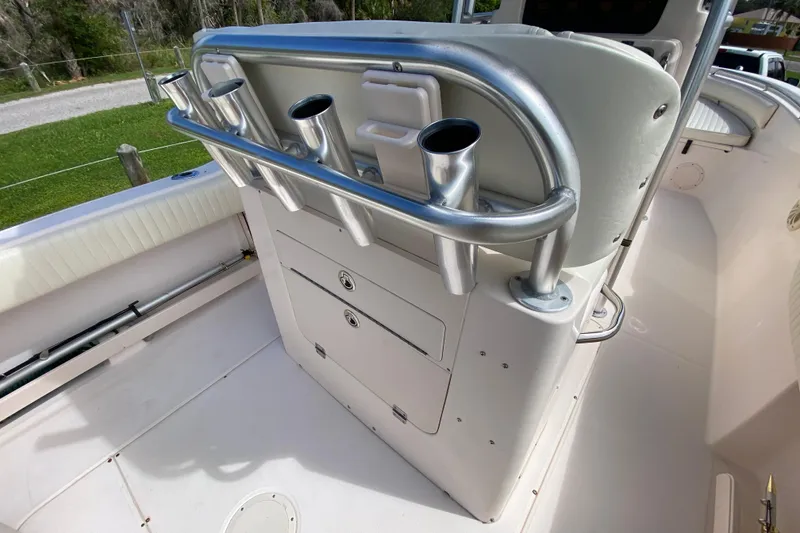 Slide: The Image of 2005 Grady-White Advance 257 boat interior with rod holders and storage compartments. - 51