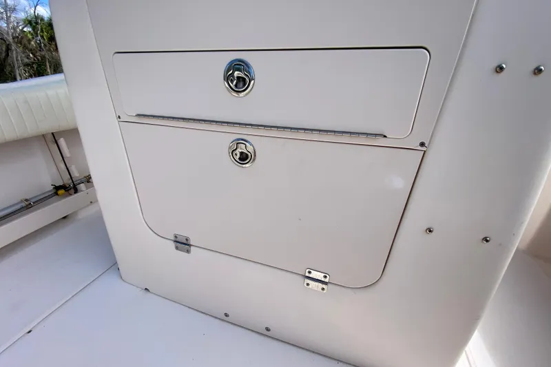Slide: The Image of 2005 Grady-White Advance 257 boat storage compartment with secure latches. - 52