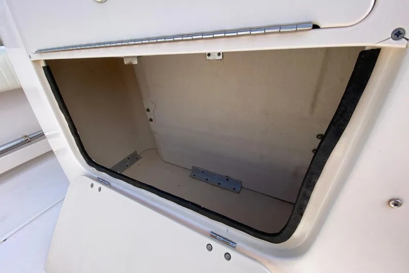 Slide: The Image of Open storage compartment on a 2005 Grady-White Advance 257 boat. - 54