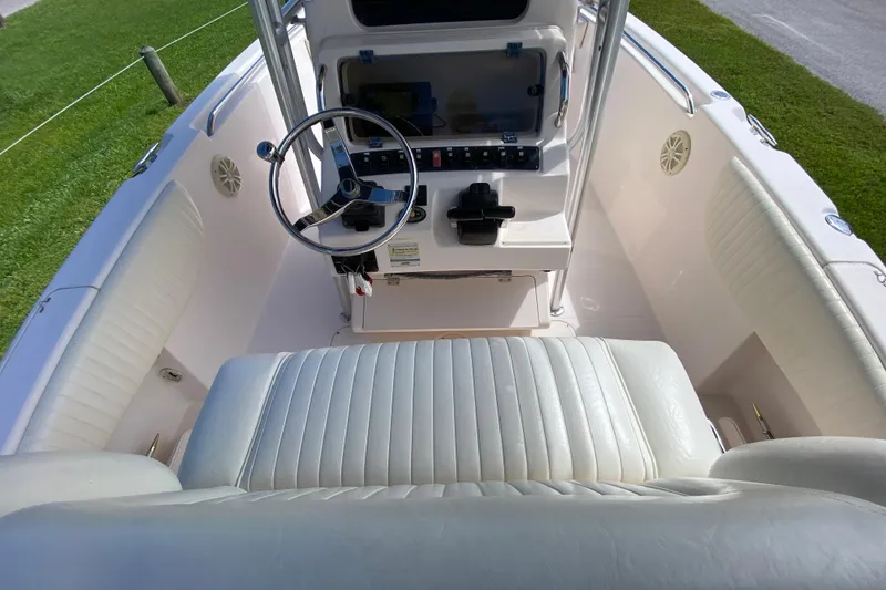 Slide: The Image of 2005 Grady-White Advance 257 boat interior with steering wheel and cushioned seating. - 55