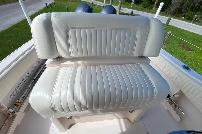 Slide: The Image of 2005 Grady-White Advance 257 boat with white cushioned seating, outdoor setting. - 57